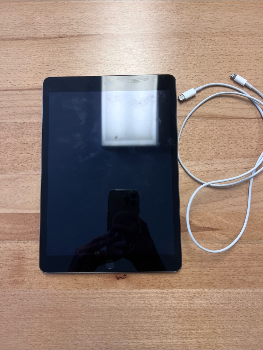 Apple Black Tablet with White Charging Cable